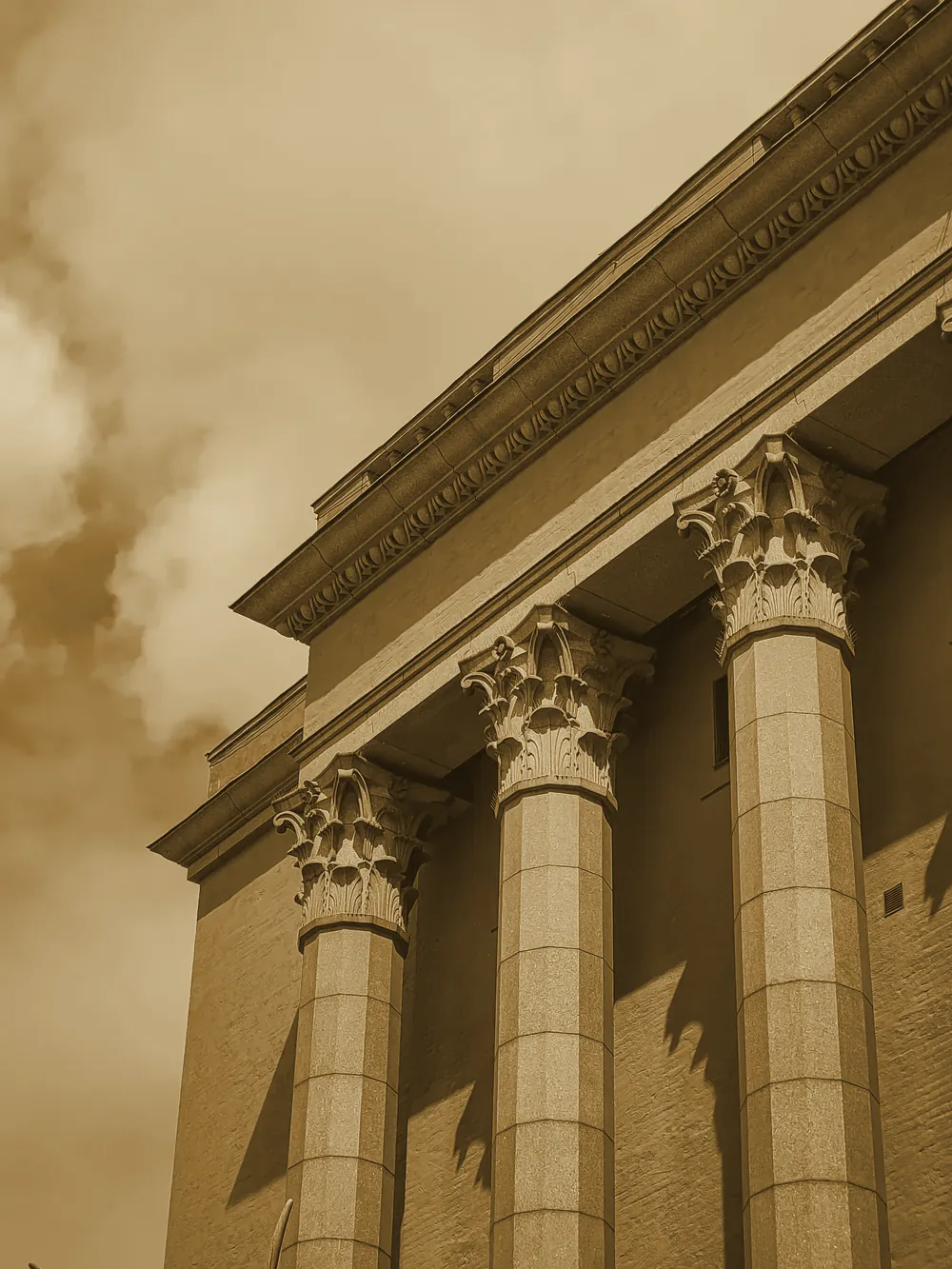 A tall historic building against a cloudy sky
