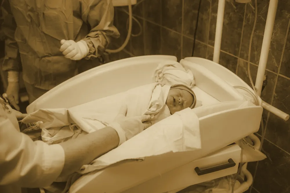 A newborn resting in a hospital bed