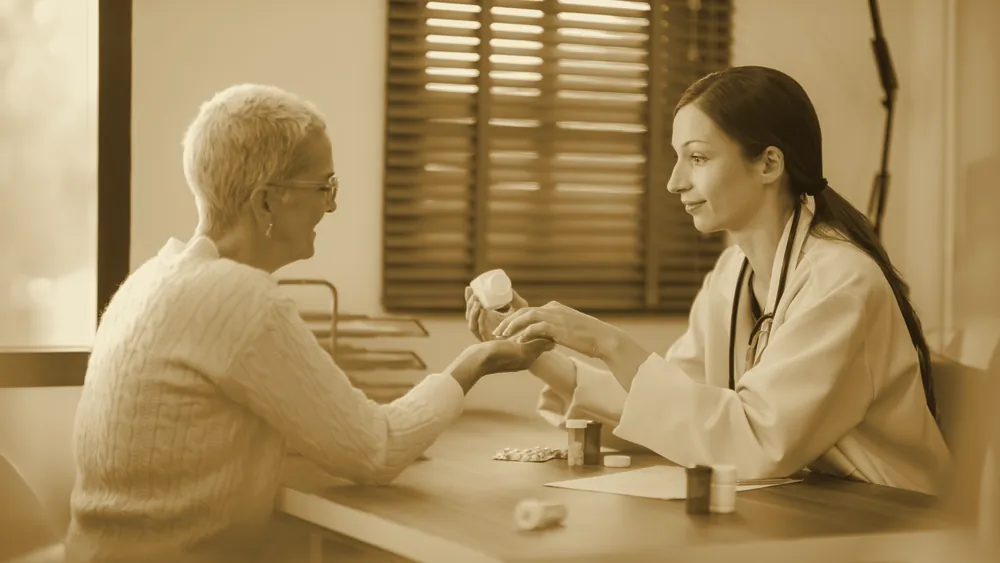 A doctor explaining treatment and medication options to an older patient