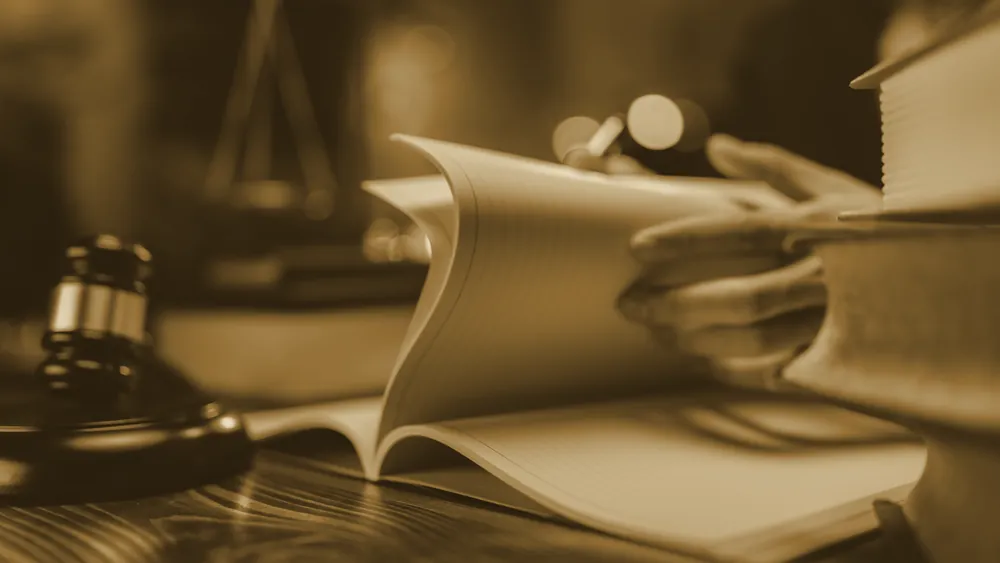 A lawyer applying an approval stamp to a legal settlement document